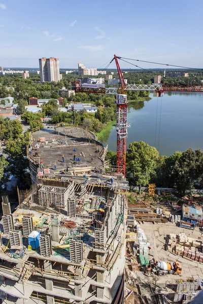 Pushkino, Russia, on August 26, 2011. A building site on the river bank. Construction of a multystoried house
