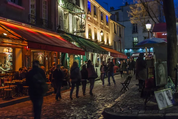 Paris, France, on March 26, 2011. Tourists walk on the evening street on Montmartre