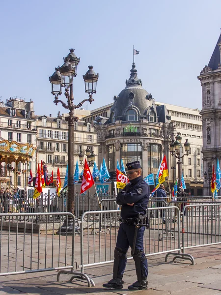 Paris, France, on March 29, 2011. Typical city landscape. The square in front of a city town hall during public action. The police officer patrols