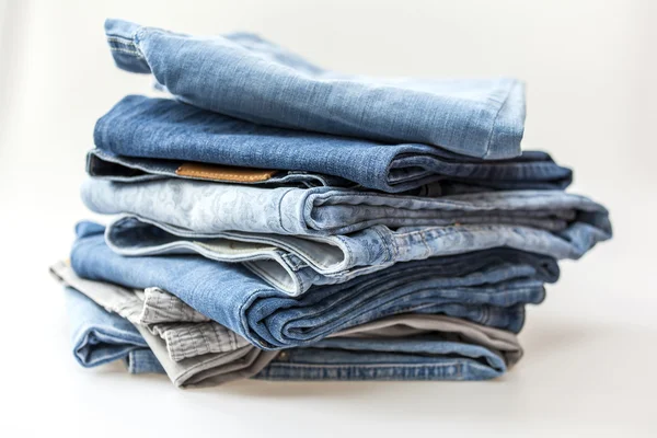 Pile of jeans of various shades