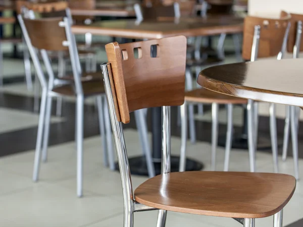 Tables and chairs in cafe in the food court of shopping center
