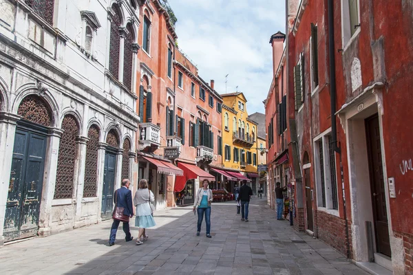 VENICE, ITALY - on APRIL 29, 2015. Pedestrians go on the narrow curve old street
