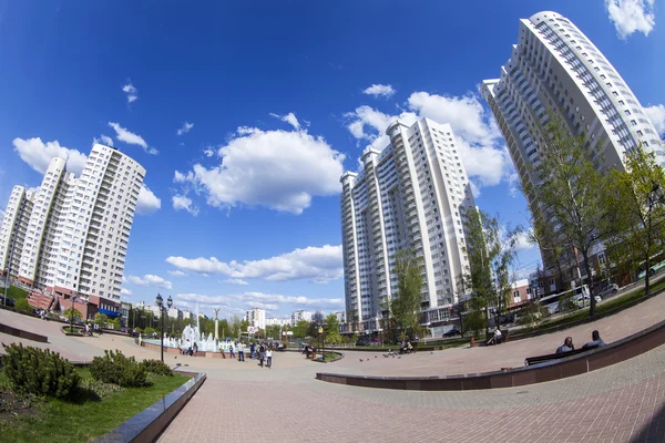 PUSHKINO, RUSSIA - on MAY 10, 2015. City landscape in the spring afternoon. A memorial in the downtown and multystoried new buildings, fisheye view.