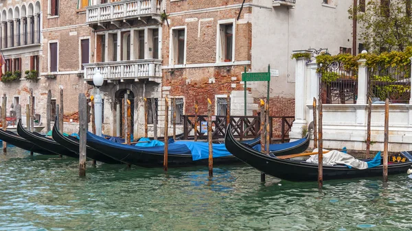 VENICE, ITALY - on APRIL 30, 2015. An architectural complex of ancient buildings on the bank of the Grand channel (Canal Grande). Gondolas at pier. The grand channel is the main transport artery of Venice and its most known channel