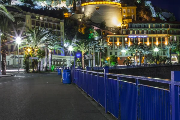 NICE, FRANCE, on MARCH 13, 2015. An English promenade (Promenade des Anglais) in evening. Belland\'s tower (Tour Bellanda). Promenade des Anglais - one of the most beautiful embankments in Europe