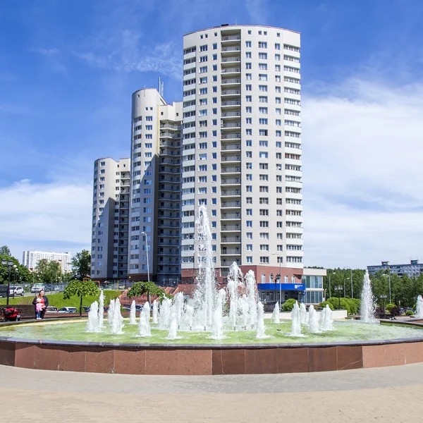 PUSHKINO, RUSSIA - on JUNE 1, 2015. City landscape in the sunny summer day. A memorial in the downtown and multystoried new buildings.