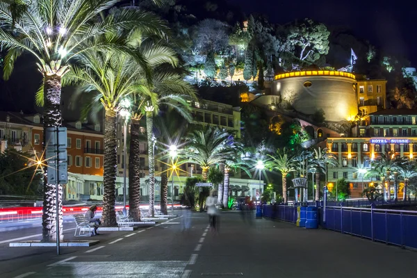 NICE, FRANCE, on MARCH 13, 2015. An English promenade (Promenade des Anglais) in evening. Belland\'s tower (Tour Bellanda). Promenade des Anglais - one of the most beautiful embankments in Europe