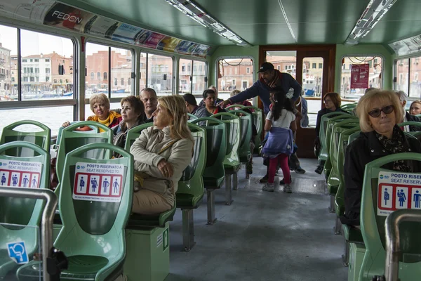 VENICE, ITALY - on APRIL 30, 2015. Passengers sit in salon вапоретто. Vaporetto - public transport in island part of Venice