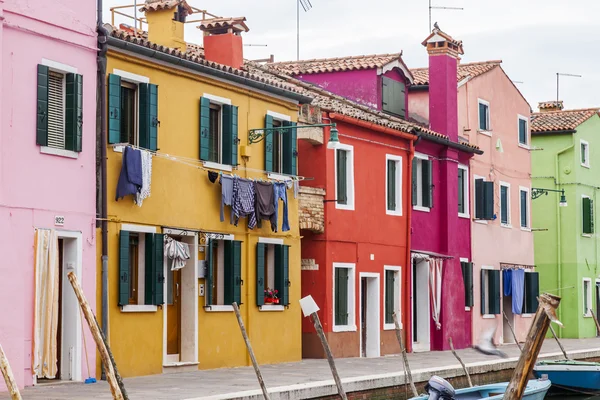 VENICE, ITALY, on APRIL 30, 2015. Multi-colored lodges on the canal embankment on Burano's island. Burano - one of islands of the Venetian lagoon