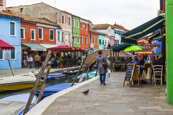 VENICE, ITALY, on APRIL 30, 2015. Burano island, typical street canal and multi-colored houses of locals. Burano the island - one of attractive tourist objects in the Venetian lagoon