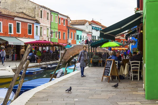 VENICE, ITALY, on APRIL 30, 2015. Burano island, typical street canal and multi-colored houses of locals. Burano the island - one of attractive tourist objects in the Venetian lagoon