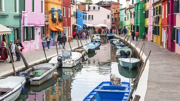 VENICE, ITALY, on APRIL 30, 2015. Burano island, typical street canal and multi-colored houses of locals. Burano the island - one of attractive tourist objects in the Venetian lagoon