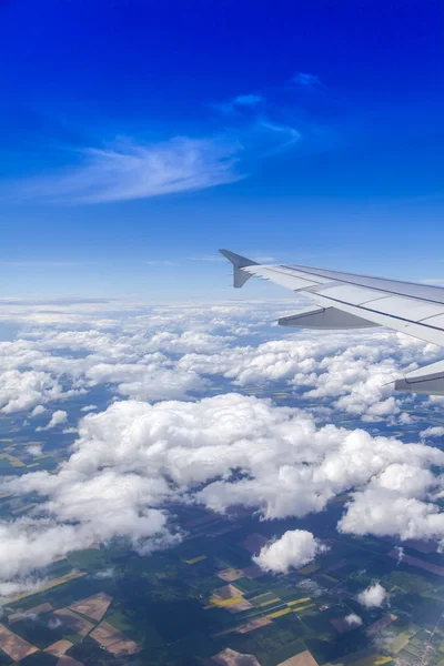 Plane view from the window on picturesque white clouds