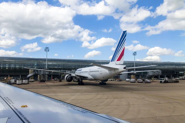 PARIS, FRANCE - on MAY 5, 2015. The international airport Charles de Gaulle, service of the plane about the terminal E. A view from the window of the flying-up plane