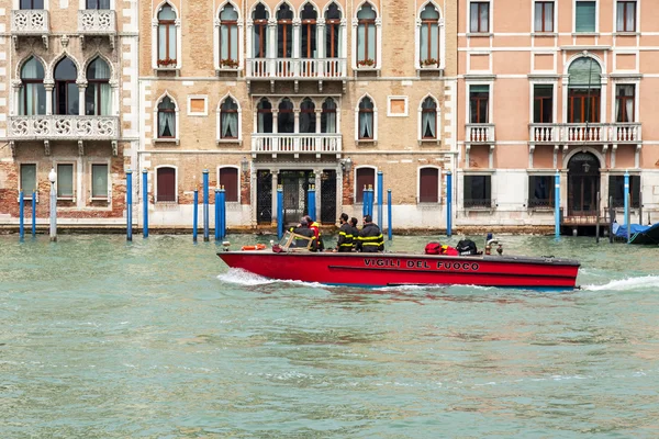 VENICE, ITALY - on MAY 4, 2015. City landscape. Gondolas are moored about the coast of the Grand channel (Canal Grande) and a typical architectural complex. The fire boat floats on the channel