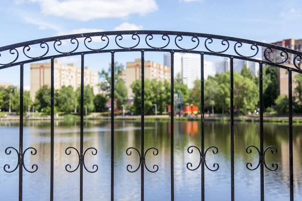 PUSHKINO, RUSSIA - on JUNE 18, 2015. A recreation area and houses near the lake. Focus on a decorative lattice