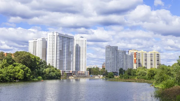 PUSHKINO, RUSSIA - on AUGUST 15, 2015. Picturesque city landscape. New multystoried houses on the river bank of Serebryanka