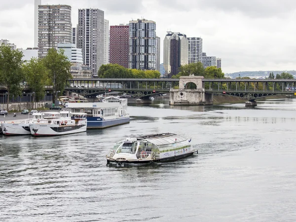 PARIS, FRANCE, on SEPTEMBER 1, 2015. A view of Seine and the walking ships moored to the embankment. Pont de Bir Hakeim in Paris. Famous bridge over the river Seine.