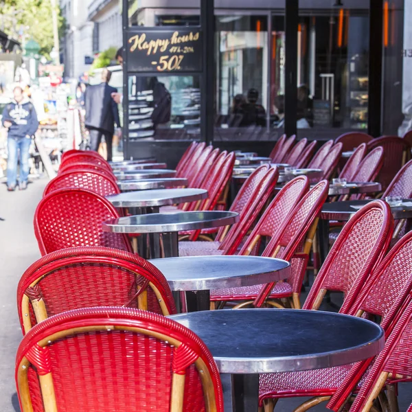 PARIS, FRANCE, on AUGUST 26, 2015. Picturesque summer cafe on the city street, red wattled chairs