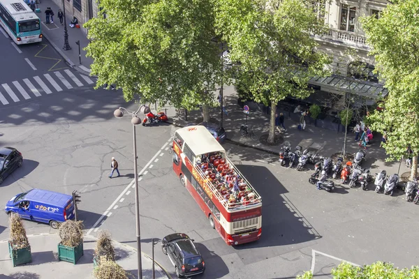 PARIS, FRANCE, on AUGUST 26, 2015. The excursion bus with passengers goes on the city street. The top view from a survey platform.