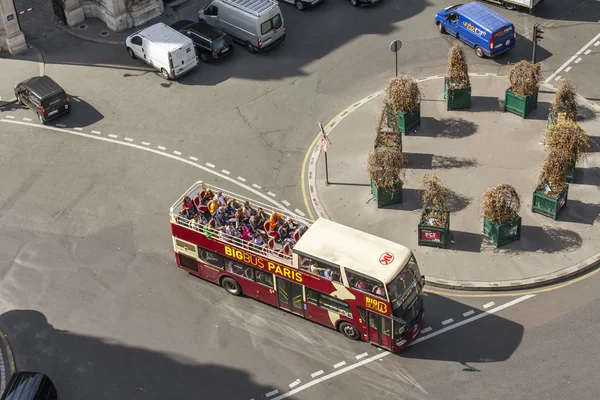 PARIS, FRANCE, on AUGUST 26, 2015. The excursion bus with passengers goes on the city street. The top view from a survey platform.