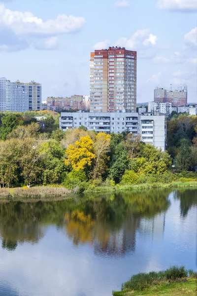 PUSHKINO, RUSSIA - on SEPTEMBER 15, 2015. City landscape in the autumn afternoon. Houses on the river bank of Serebryanka