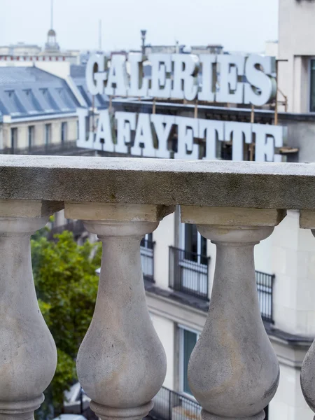 PARIS, FRANCE, on AUGUST 27, 2015. A view from a balcony with a beautiful protection on the city in rainy weather. Roofs of Paris wet from a rain