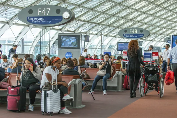 PARIS, FRANCE - on SEPTEMBER 1, 2015. The international airport Charles de Gaulle, passengers in a hall of a departure expect boarding