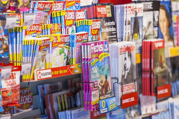 PARIS, FRANCE, on AUGUST 29, 2015. Various French magazines on a booth show-window on sale of the press