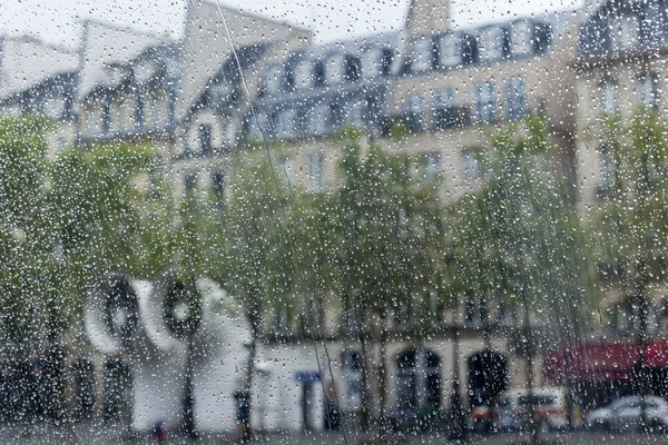 PARIS, FRANCE, on AUGUST 27, 2015. A view of the square in front of the Centre Georges Pompidou through a wet window. It is raining, water drops on glass