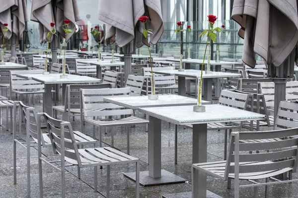 PARIS, FRANCE, on AUGUST 26, 2015. Picturesque summer cafe on a survey platform on a roof. Rainy day, wet tables with water drops