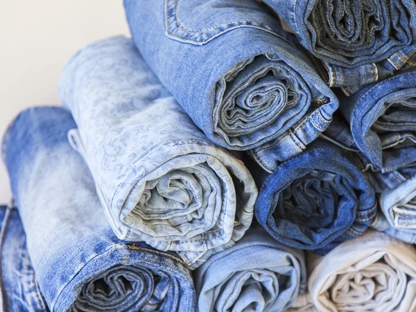 The jeans curtailed in a roll on a counter of shop