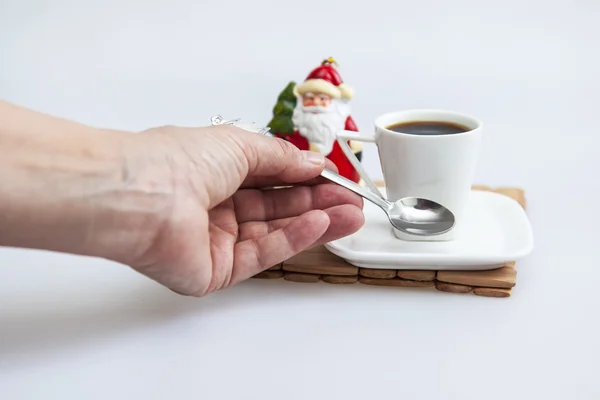 Cup with black coffee and Father Frost\'s figure