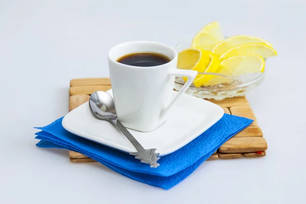 Cup of coffee of espresso and slices of a lemon on a background