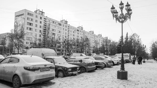 City landscape in the winter afternoon. A view of a parking of cars on the city street