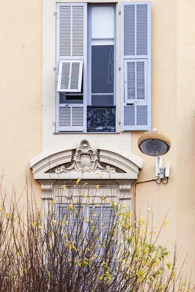 NICE, FRANCE, on JANUARY 7, 2016. Typical architectural details of houses in historical part of the city. Window and balcony.