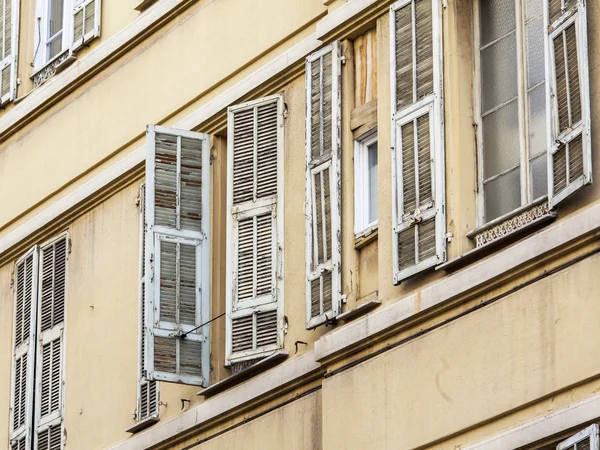 NICE, FRANCE, on JANUARY 7, 2016. Typical architectural details of houses in historical part of the city. Window and balcony.