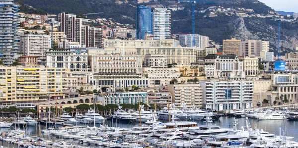 MONTE-CARLO, MONACO, on JANUARY 10, 2016. A view of houses on a slope of the mountain and yachts on the bay