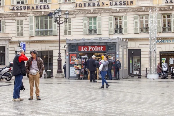 NICE, FRANCE - on JANUARY 11, 2016. A typical urban view in rainy weather. Passersby go on Yustitsii Square