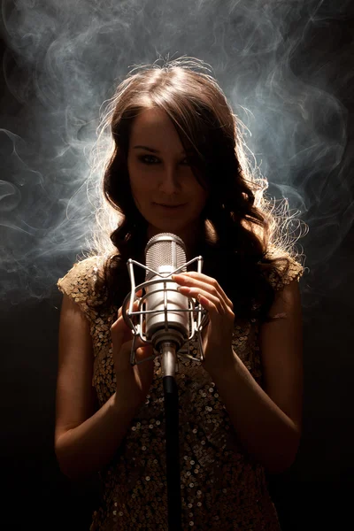 Picture of beautiful singer with studio microphone