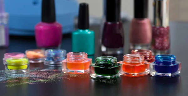 Closeup of gel polishes and powder for nails