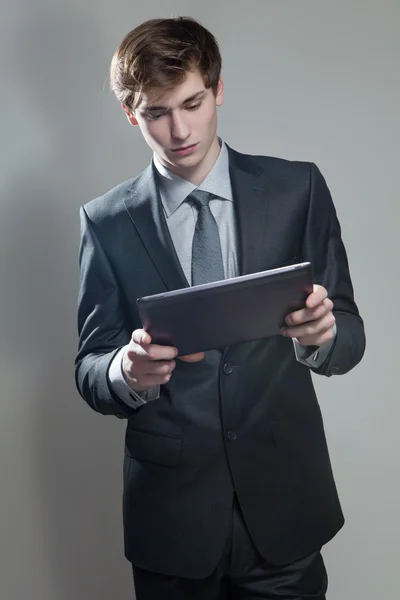 Young businessman with touch screen computer