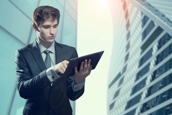 Young businessman with touch screen computer