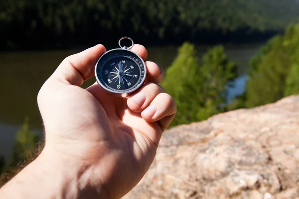 Hand holding the compass