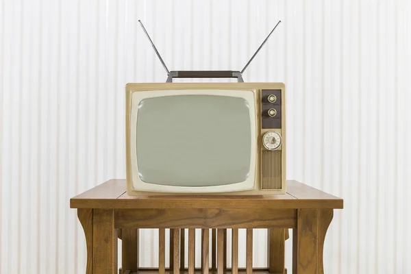 Old Television with Antenna on Wood Table