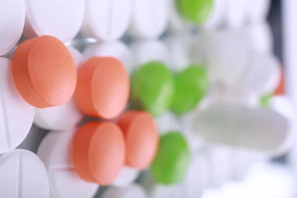 Red and white pill capsules pile