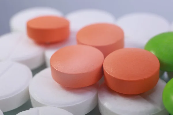 Red and white pill capsules pile