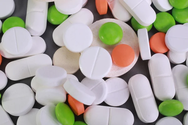 Red and white pill capsules pile