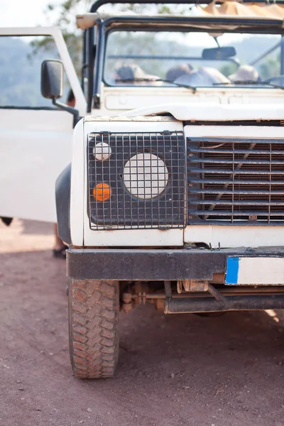 Close-up photo of white old suv at the off-road