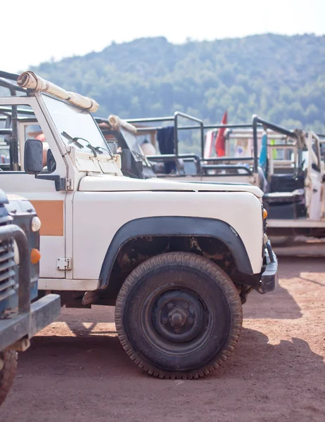 Close-up photo of white old suv at the off-road